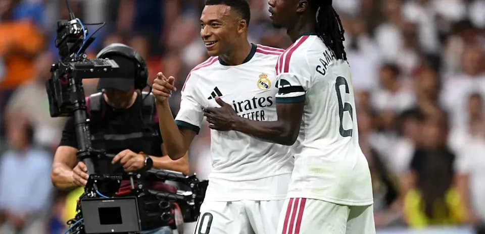 Two Real Madrid players celebrating on the field