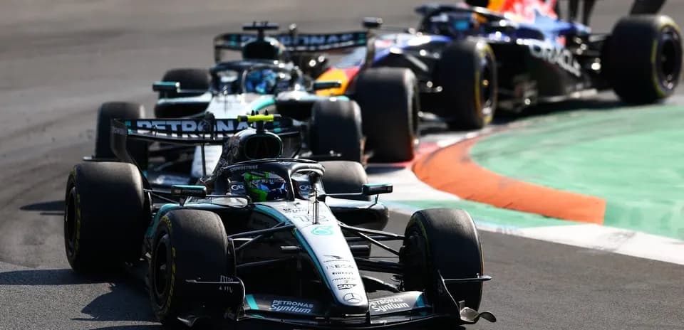 Three Formula 1 cars racing on track