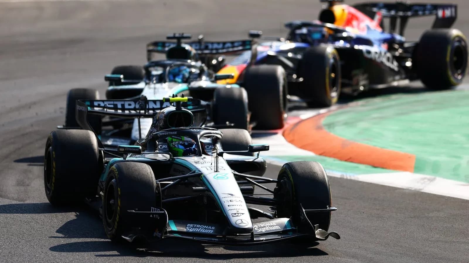Three Formula 1 cars racing on track