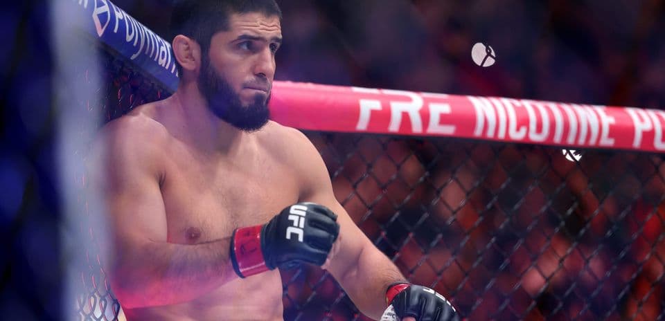 Fighter sitting in the UFC octagon between rounds