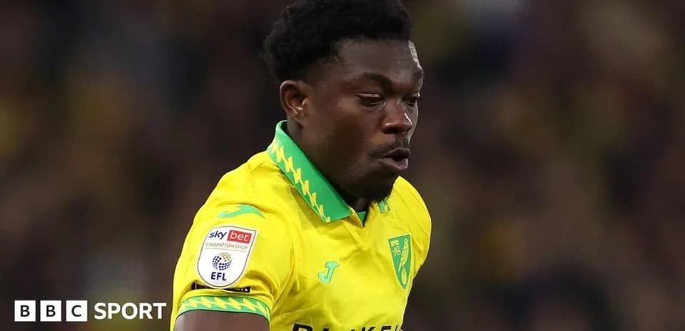 Player in yellow jersey running on the pitch