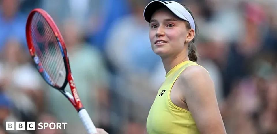 Tennis player smiling with racket on court