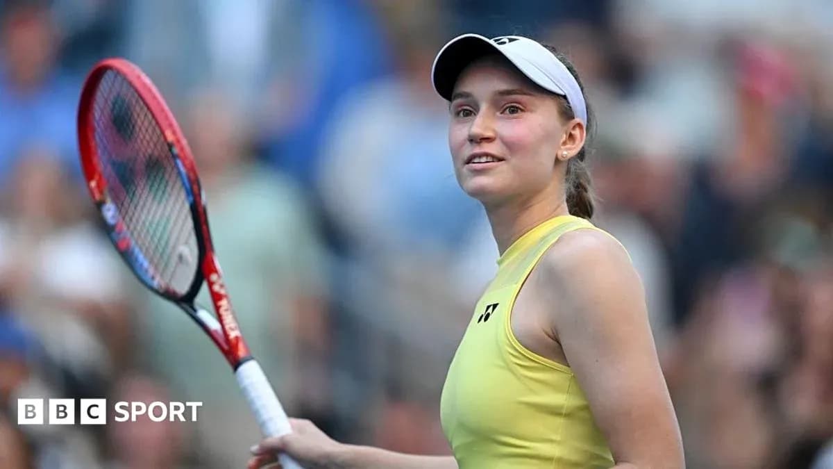 Tennis player smiling with racket on court