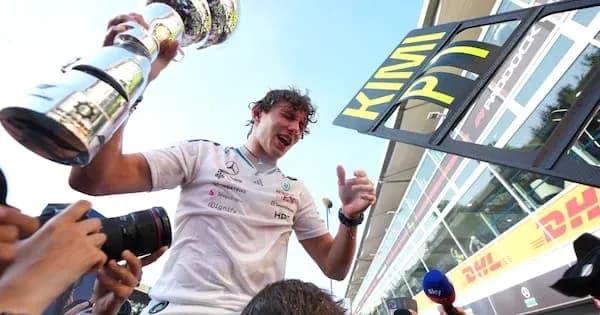 Driver celebrating with trophy after race victory