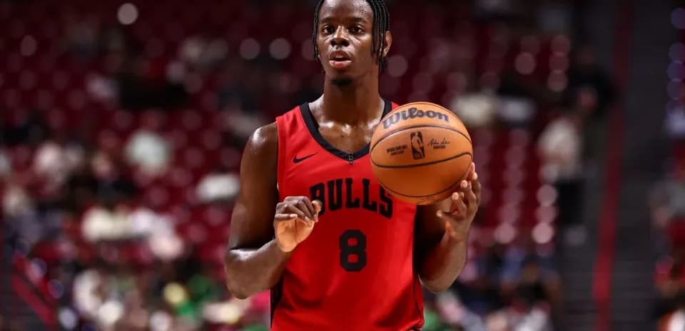 Player in Bulls jersey preparing to shoot basketball