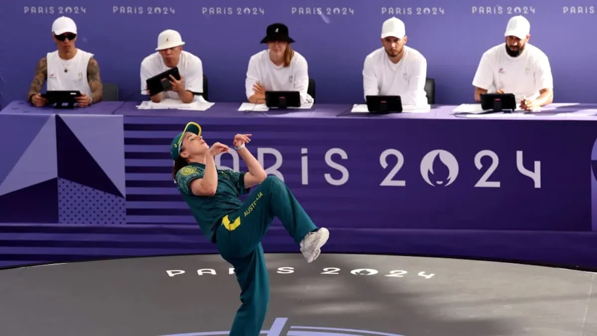 Athlete performing at Paris 2024 event with judges
