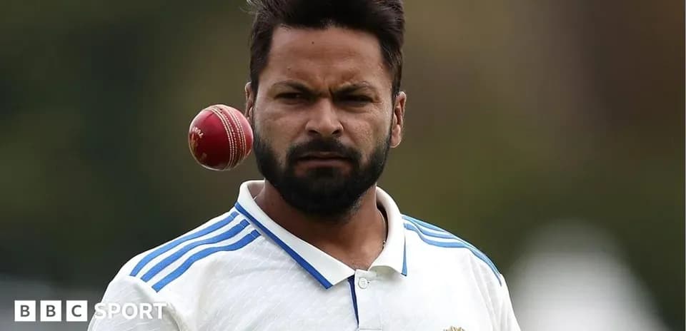Cricketer preparing to bowl with a cricket ball