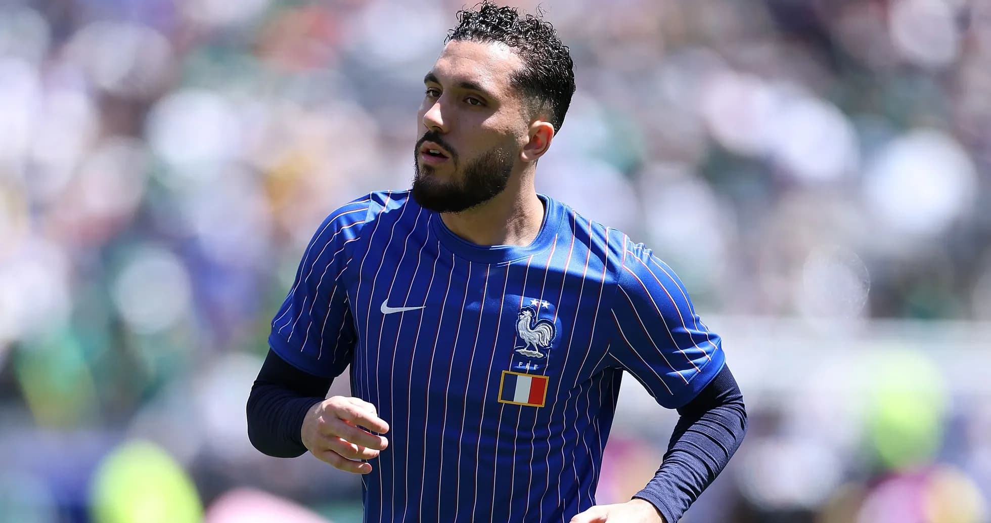 Player in blue France jersey running on field
