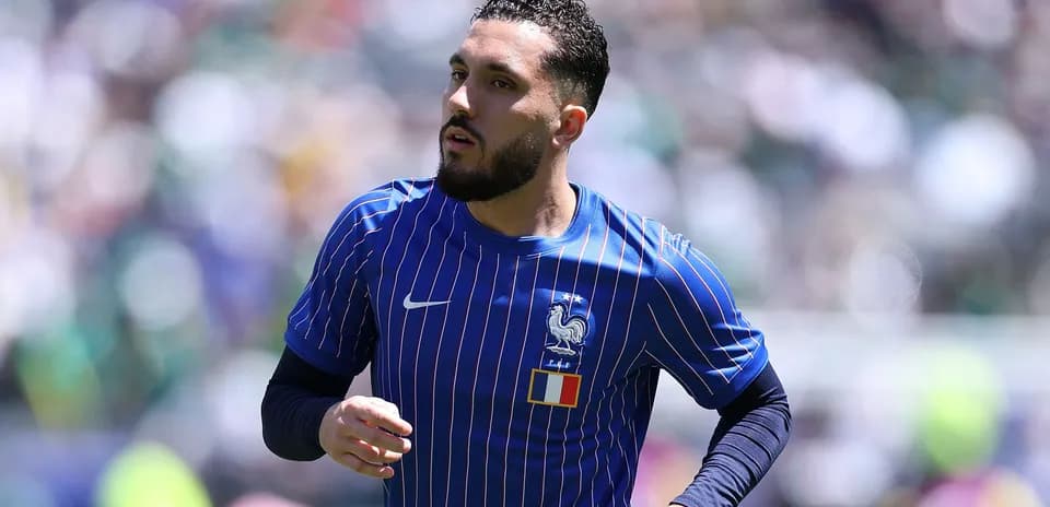 Player in blue France jersey running on field