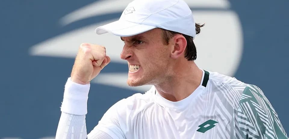 Tennis player celebrating a point with a fist pump