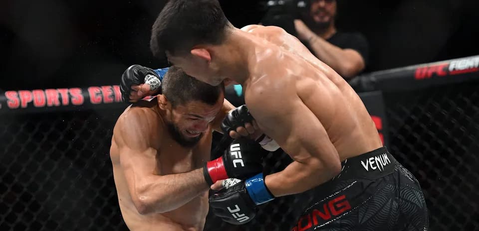 Two fighters exchanging punches in an MMA match