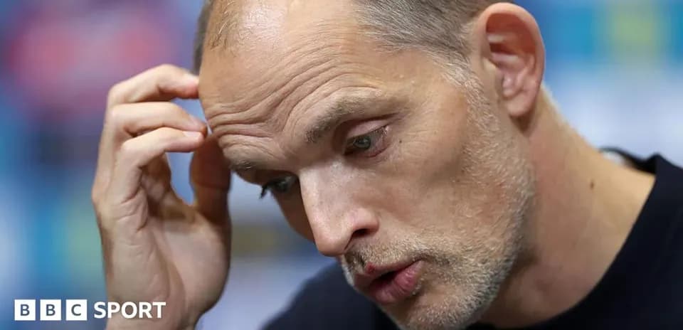 Manager at press conference with thoughtful expression