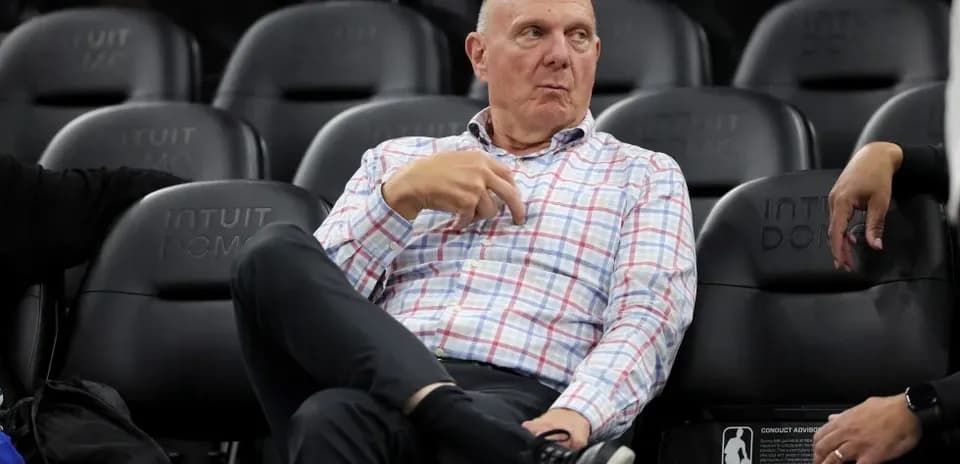 Executive seated in arena during basketball game