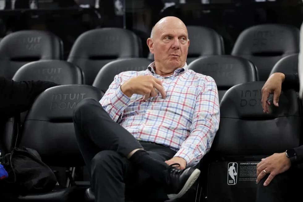 Executive seated in arena during basketball game