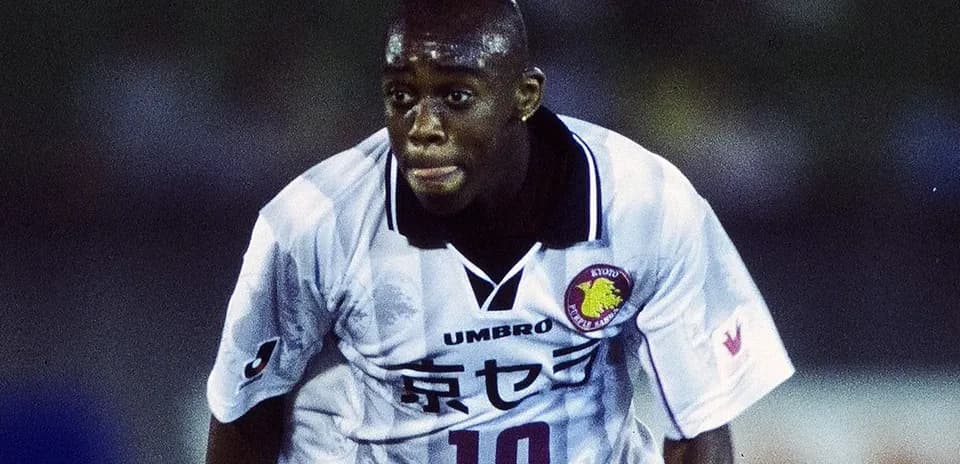 Player in action wearing a white football jersey