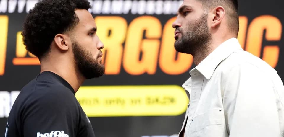 Two boxers facing off at a press conference