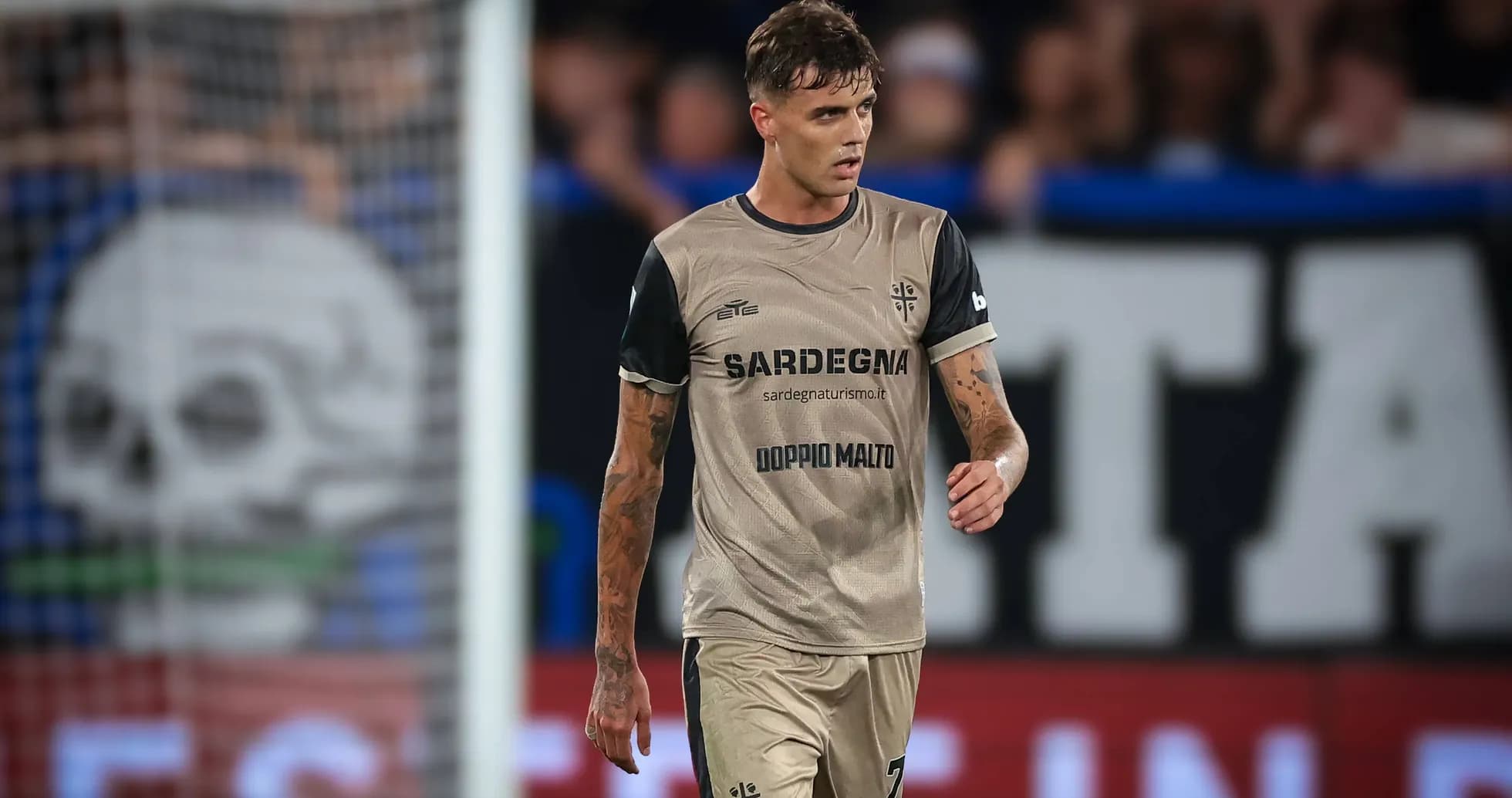 Player walking on the pitch in team uniform
