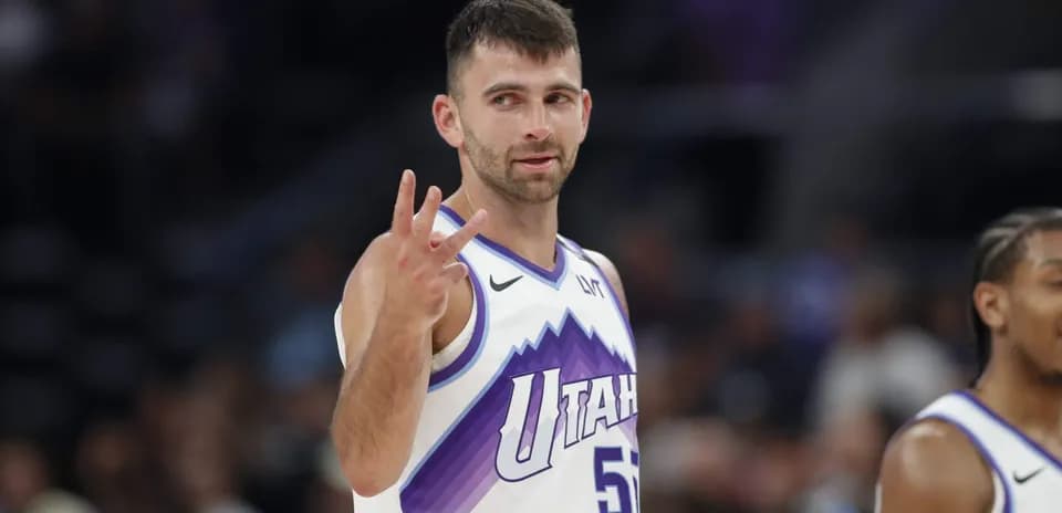 Player signaling three points during basketball game