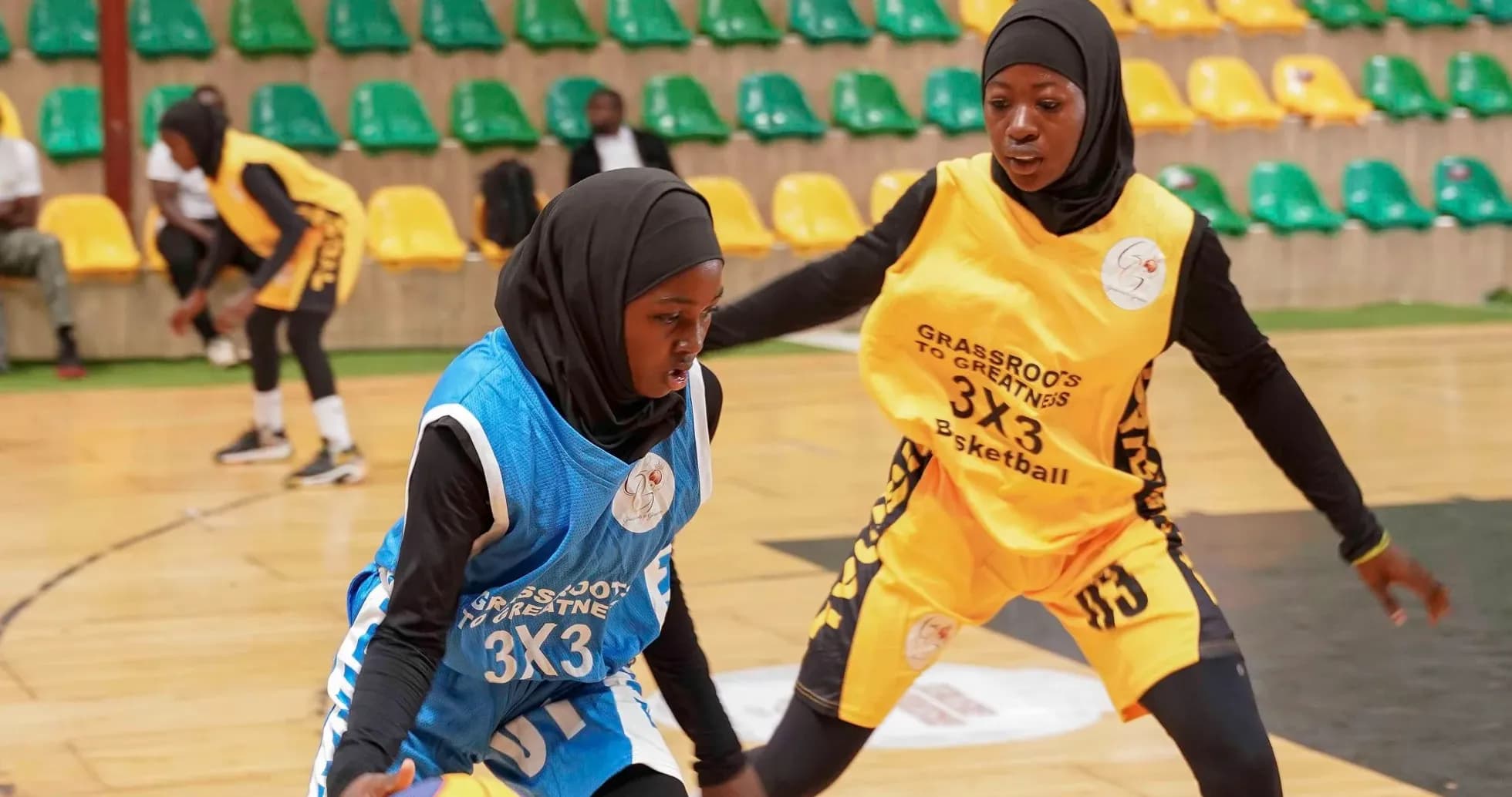 Two players competing for the ball in basketball game