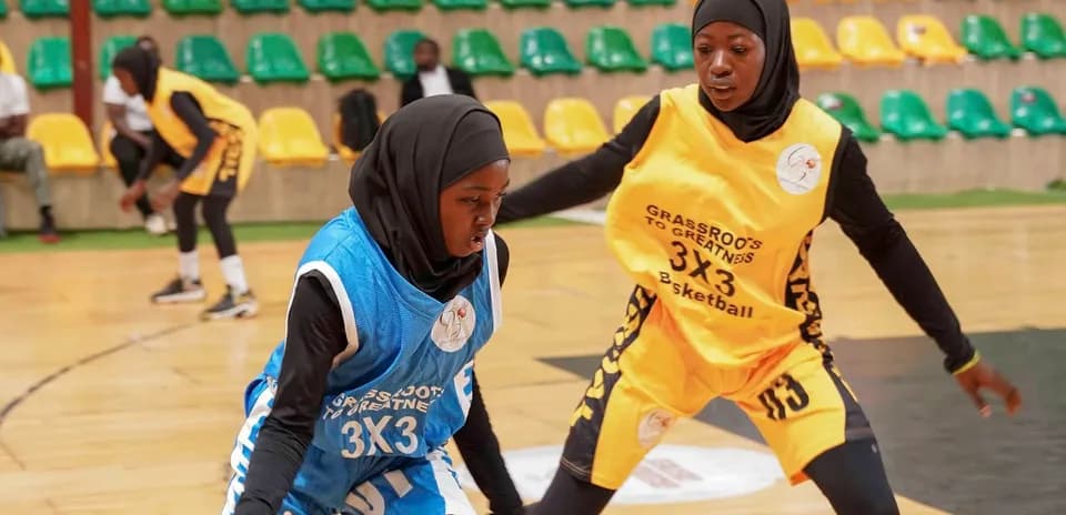 Two players competing for the ball in basketball game