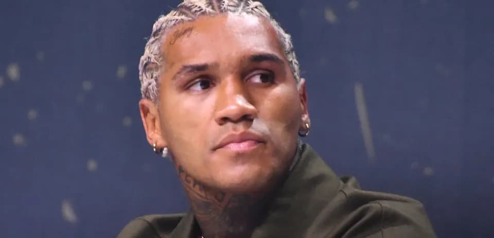 Athlete with braided hair at a press conference