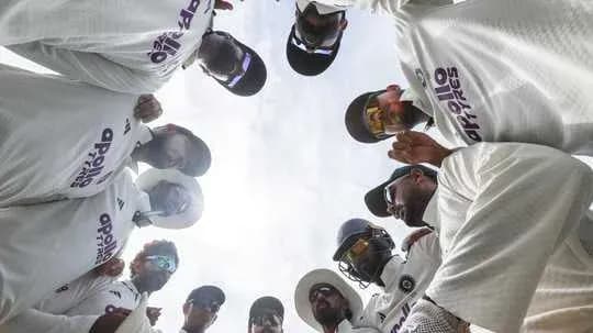 Cricket team huddled together in discussion