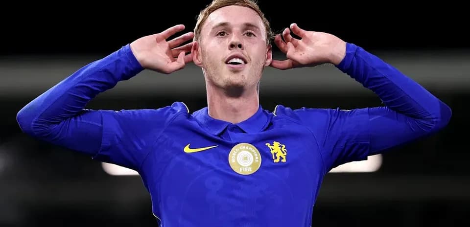 Player celebrating with hands on ears in blue jersey