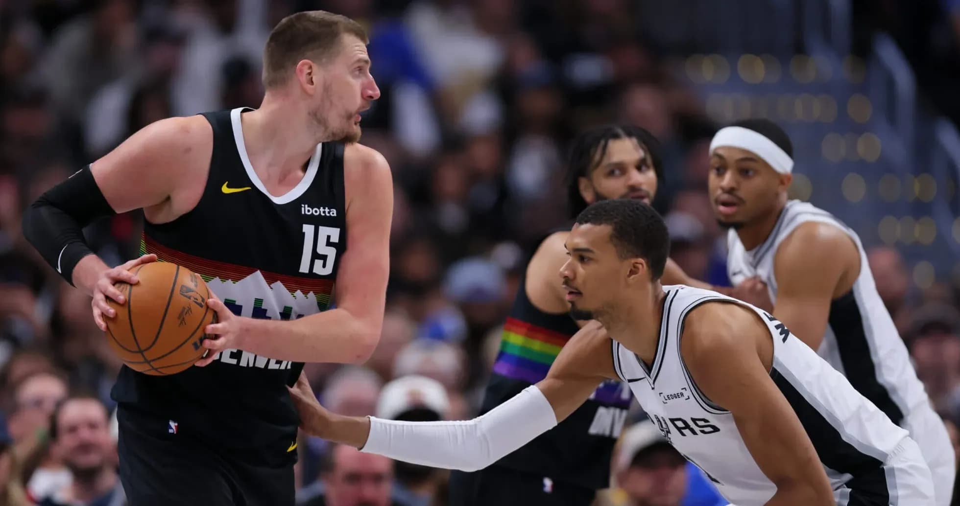 Player dribbling basketball while being guarded