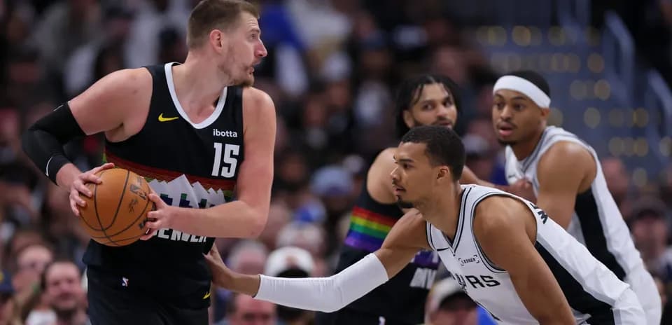 Player dribbling basketball while being guarded