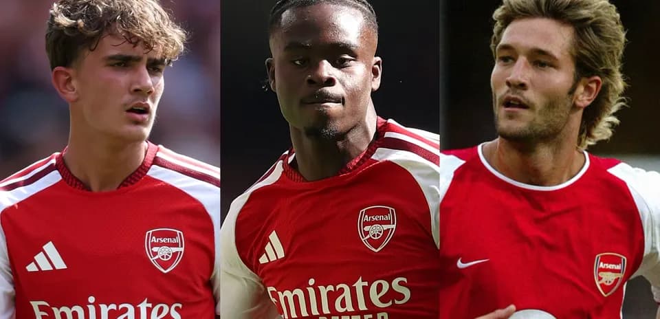 Three Arsenal players in red kits during match