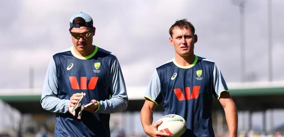 Two cricket players walking during training session