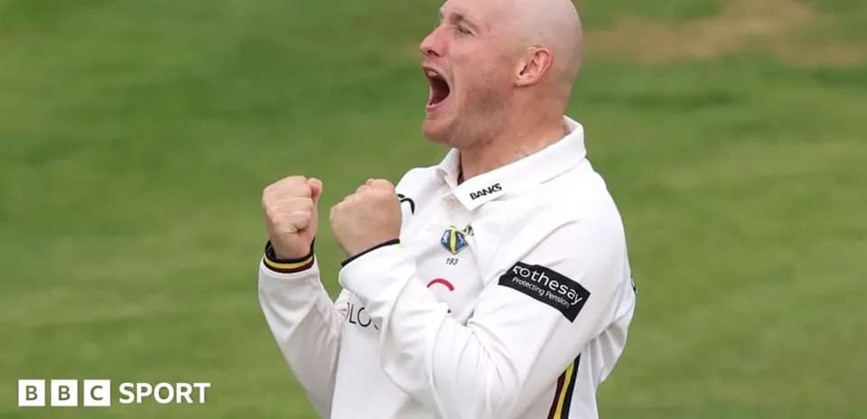 Cricketer celebrating a wicket with clenched fists
