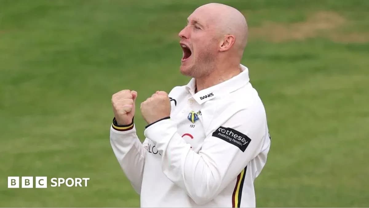Cricketer celebrating a wicket with clenched fists