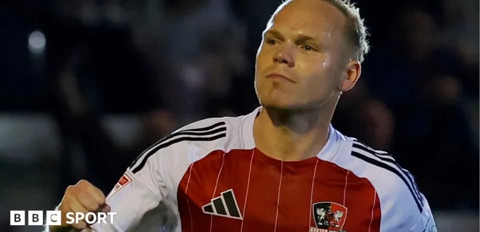 Player celebrating in Exeter City FC jersey
