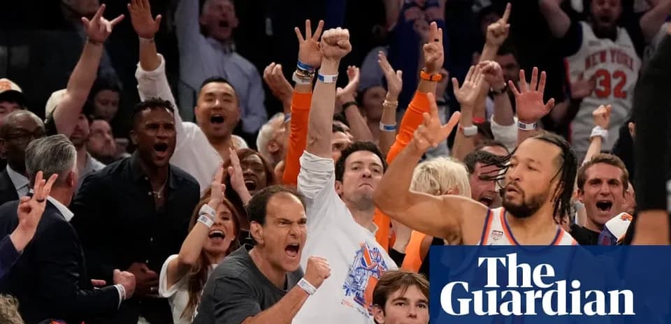 Excited crowd cheering at a basketball game