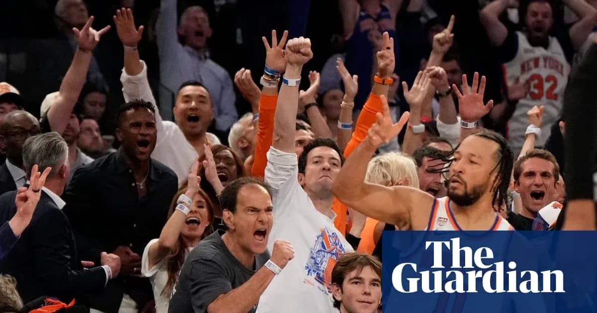 Excited crowd cheering at a basketball game