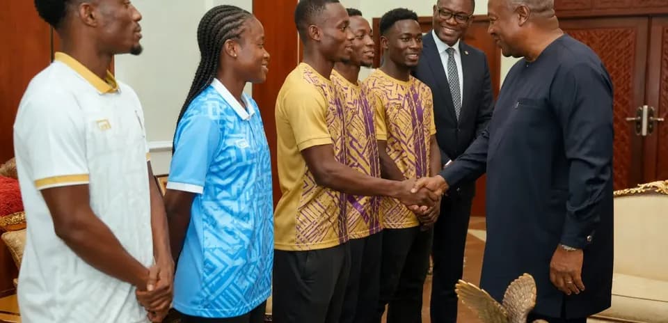 Athletes meeting with dignitaries in formal setting