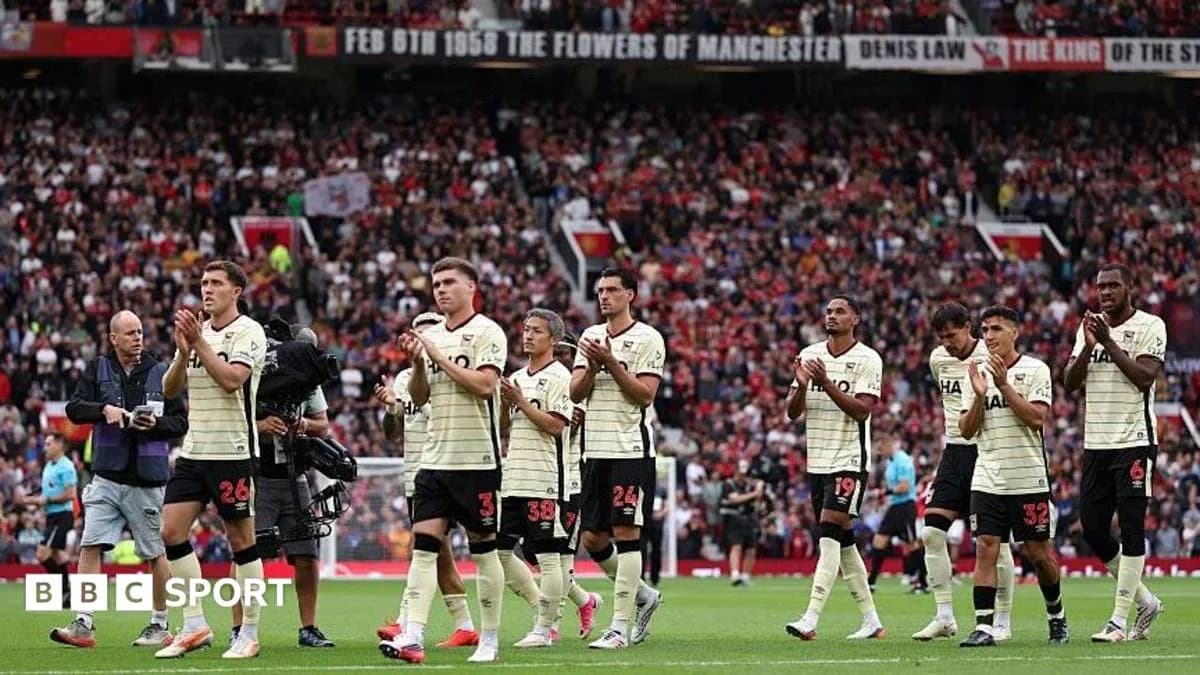 Players applauding fans at stadium after match