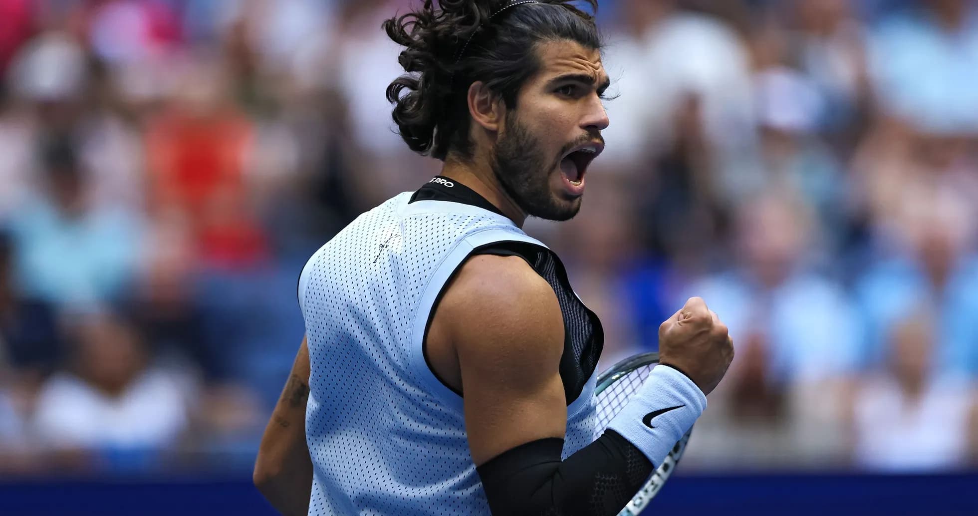 Tennis player celebrating victory during match