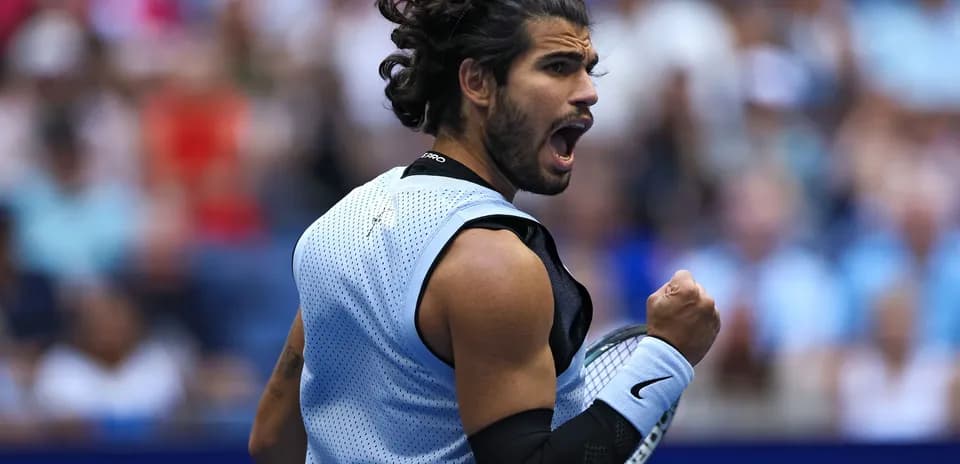 Tennis player celebrating victory during match