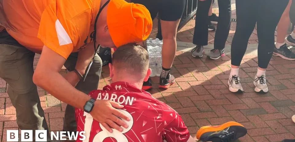 Supporter assisting runner after a race