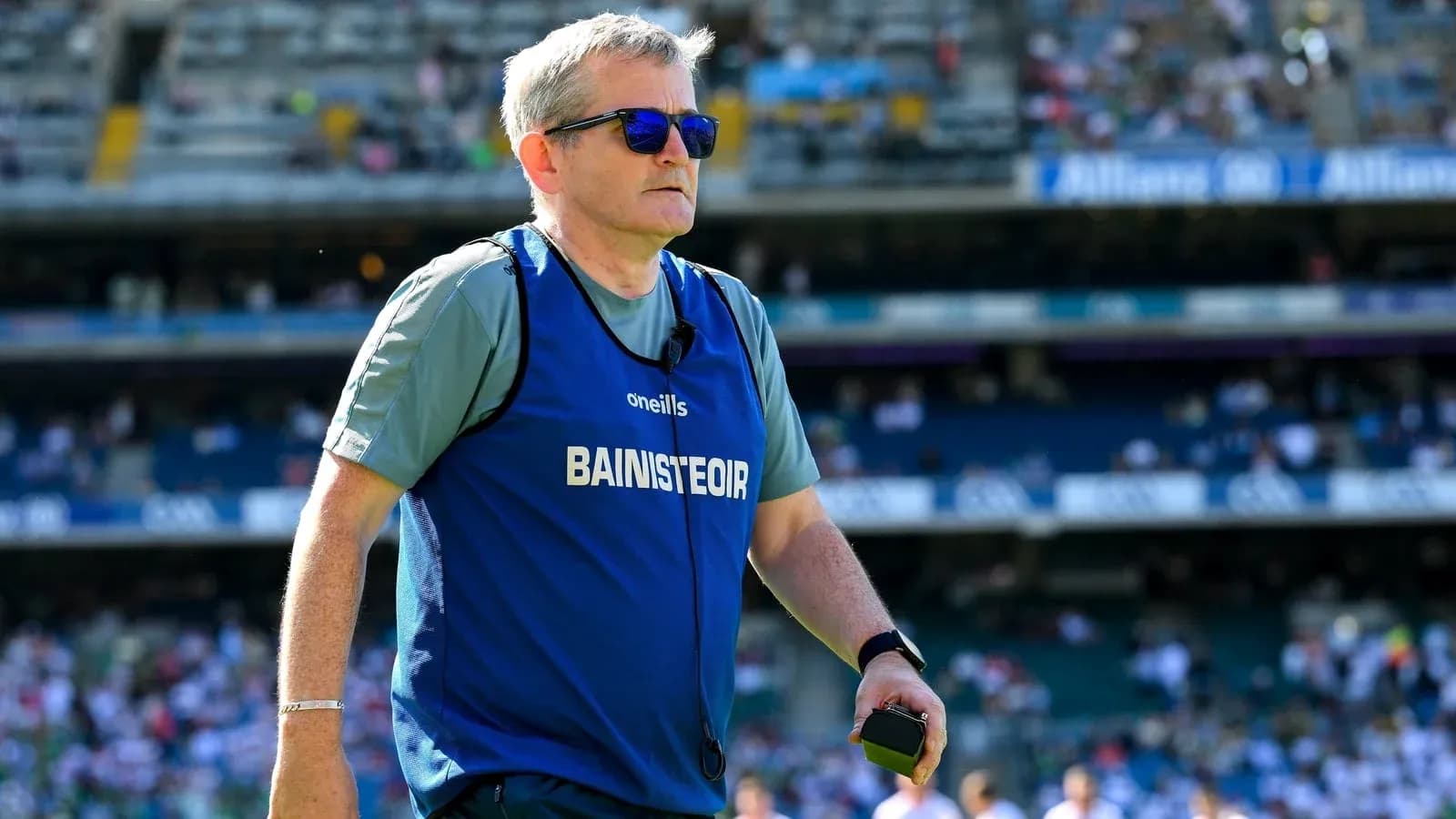 Coach walking on the field during warm-up