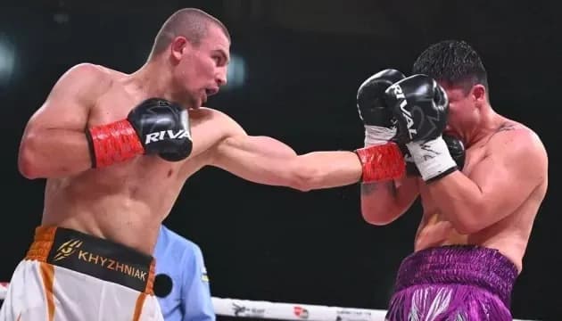 Boxer throwing a punch at opponent during match
