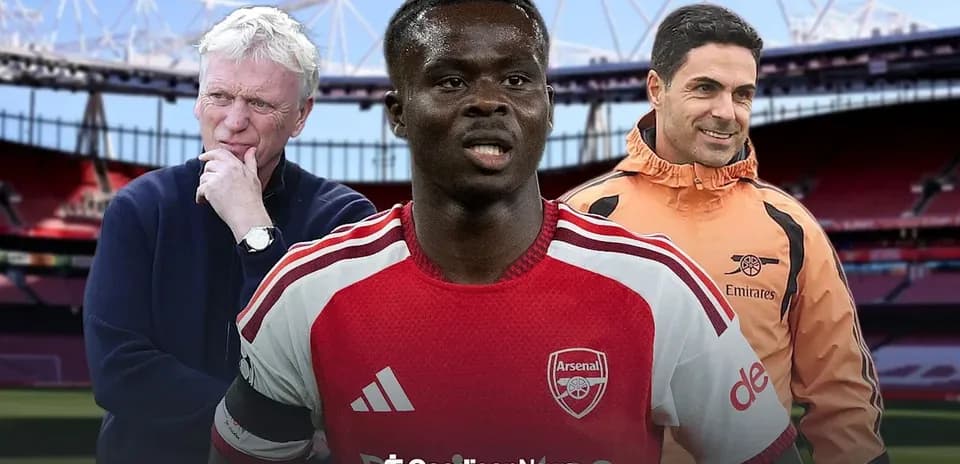 Coaches and player in Arsenal kit at stadium