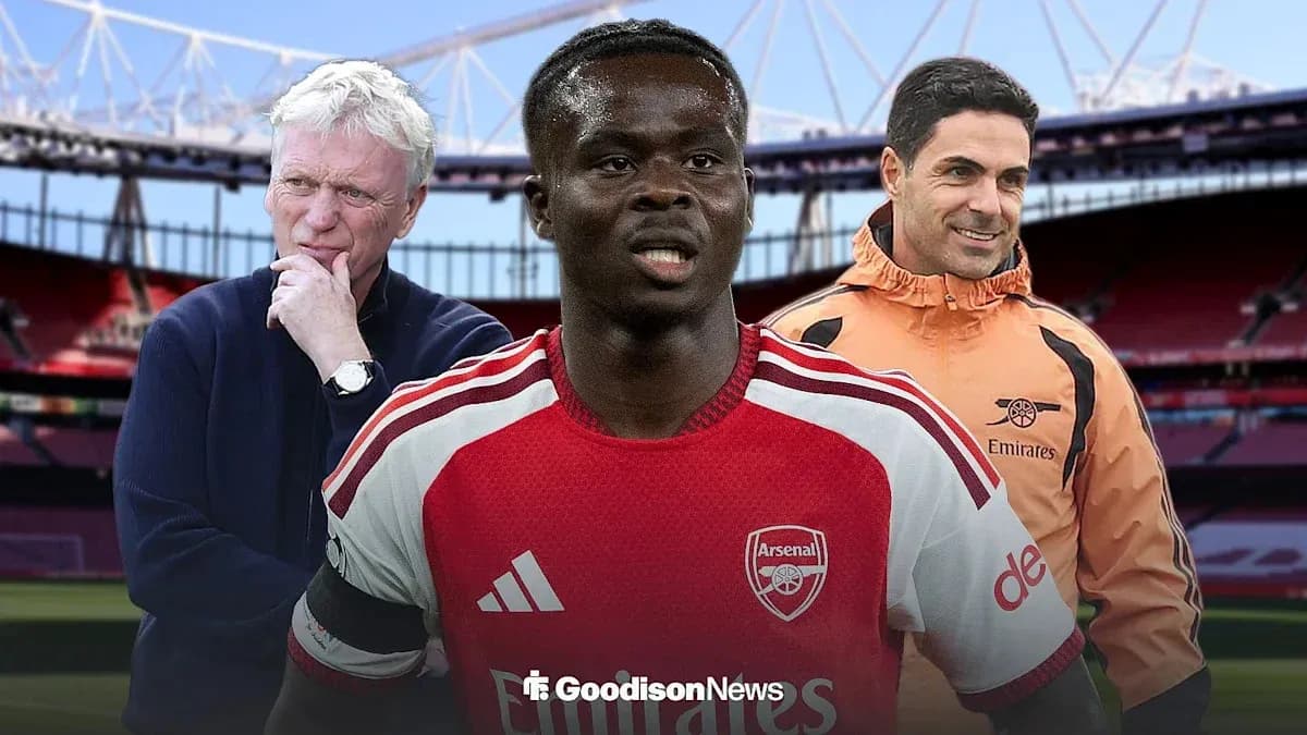 Coaches and player in Arsenal kit at stadium