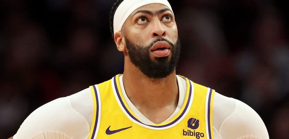 Player in Lakers jersey looking upwards during game