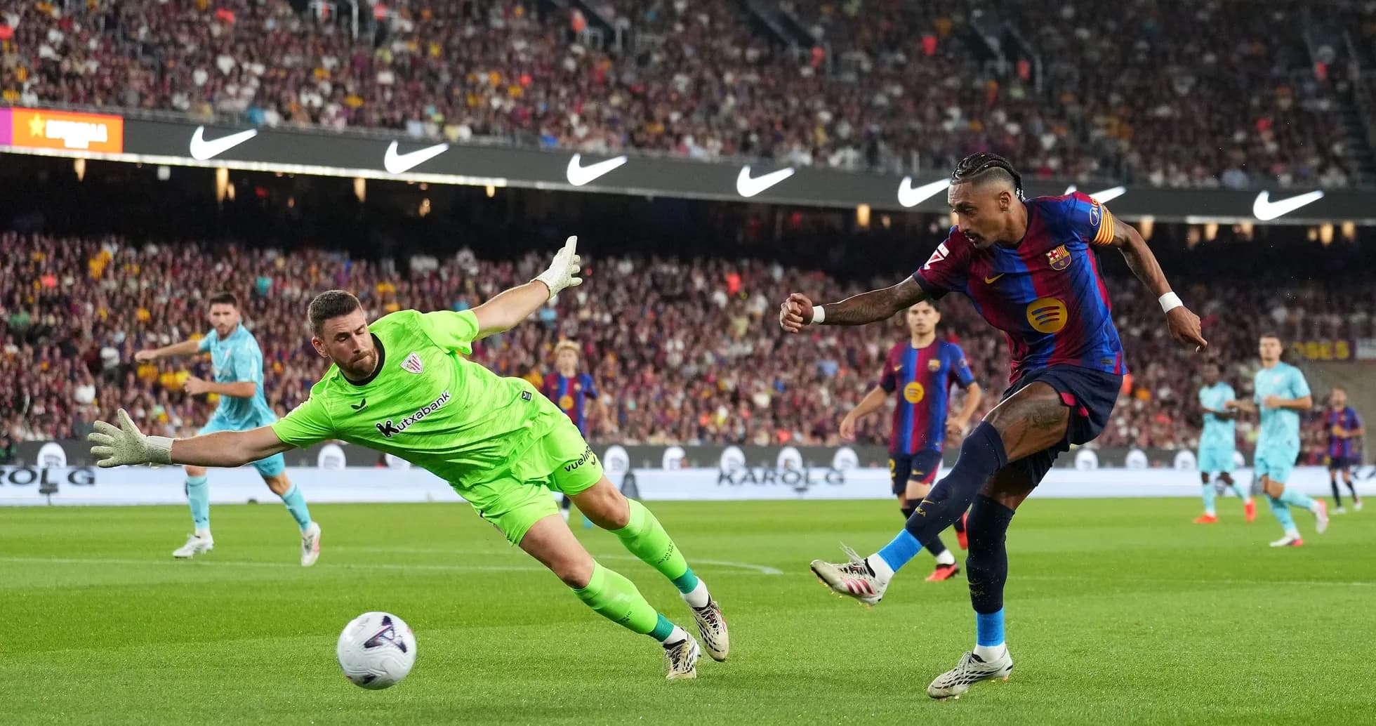 Player attempting to score as goalkeeper dives