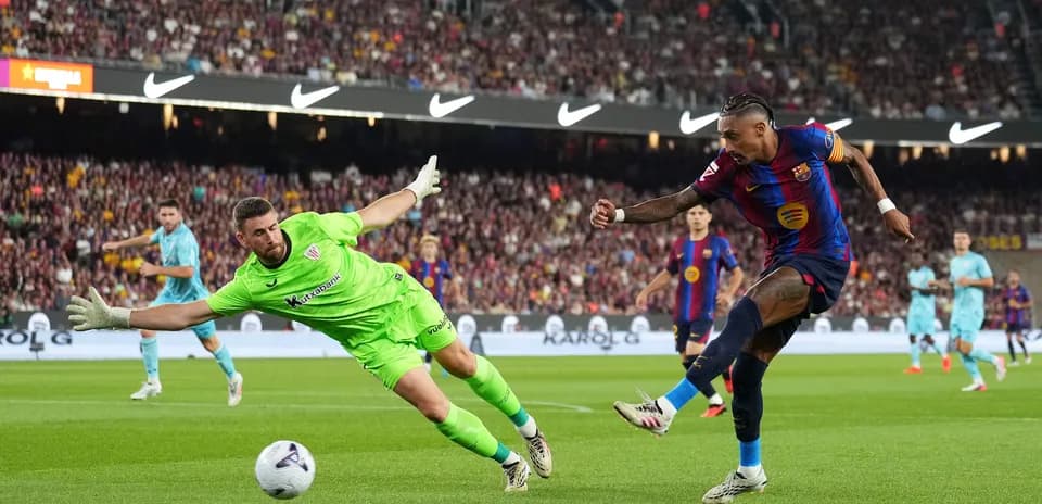 Player attempting to score as goalkeeper dives