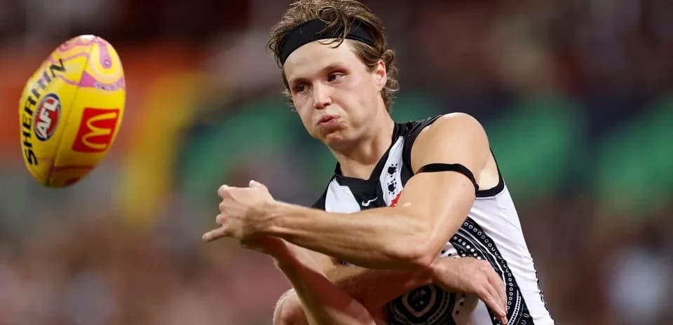 Player kicking an AFL football during match