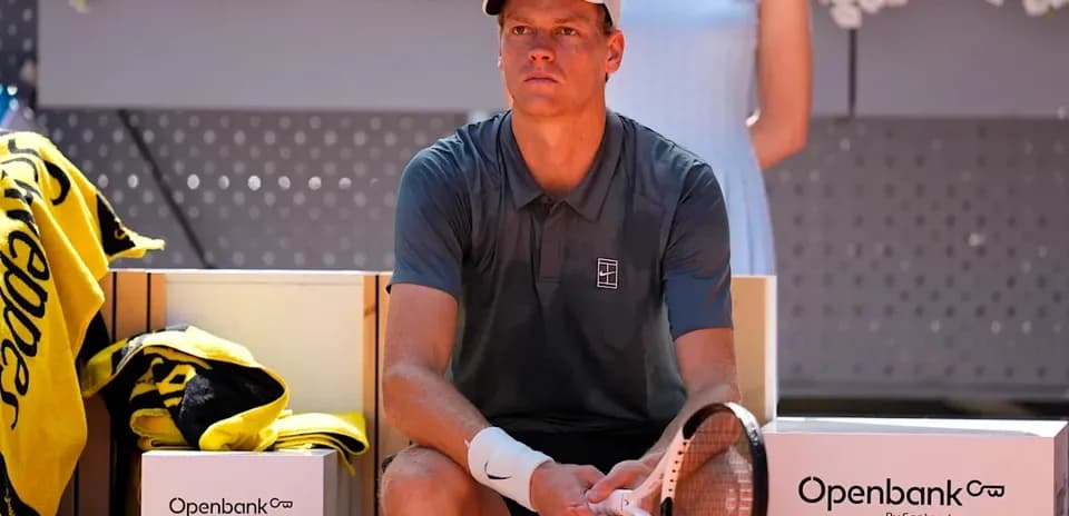Tennis player seated on bench during match break
